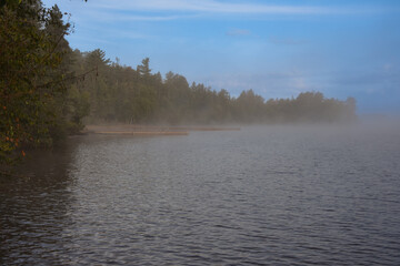 Obraz na płótnie Canvas Morning mist on a Canadian lake in the province of Quebec