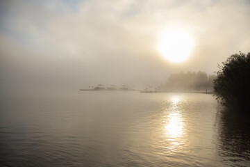 Fototapeta na wymiar Morning mist on a Canadian lake in the province of Quebec