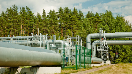 pipeline, in the photo the pipeline against the background of the blue sky of the forest and clouds