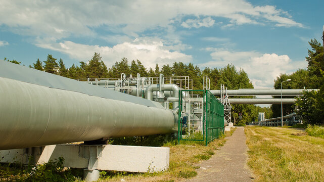 pipeline, in the photo the pipeline against the background of the blue sky of the forest and clouds