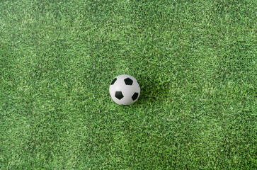 A football ball on green grass. Creative concept for Qatar FIFA World Cup 2022 advertisement of banner. Design for soccer matches tv commercial