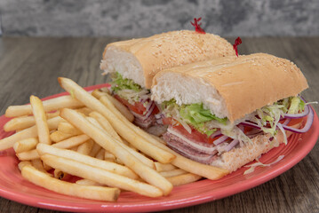 Enormous Italian cold cuts sandwich is loaded with cotto salami, provolone cheese, tomato and onion...