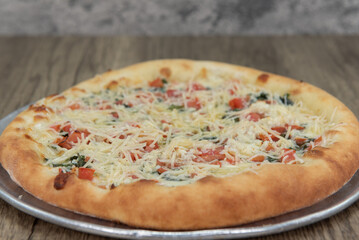 Authentic Italian margherita is hot from the oven and ready to be cut into pie size pieces to eat