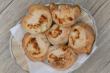 Overhead view of full basket of garlic and cheese rolls makes the perfect appetizer before an Italian food meal