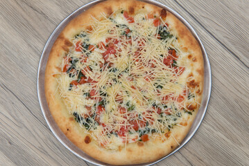 Overhead view of authentic Italian margherita is hot from the oven and ready to be cut into pie size pieces to eat