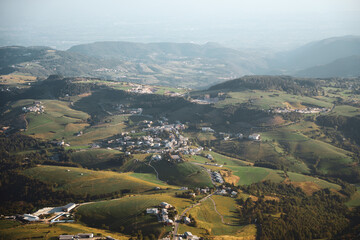 Panorama of the Lessini mountains. Lessinia National Park, near Verona and Lake Garda. Landskape from the Corno D'Aquilio viewpoint. Val d'Agide, hills, roads and villages.