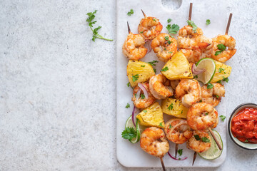 kebab skewers of barbecued shrimp with a pineapple - obrazy, fototapety, plakaty