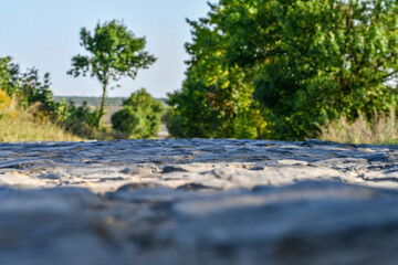 Typical rural road paved with stones in the countryside. Selective focus