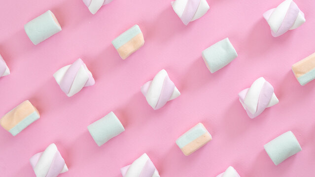 Multicolored marshmallows on a pink background, screensaver, collage