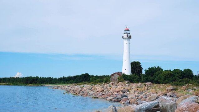 Beautiful lighthouse near the sea in a small village in clear weather