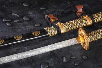 Japanese samurai katana sword and scabbard close up. Photo of a weapon in low key with selective...