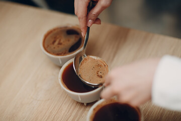 Cup Taster Woman with Spoon in Hands Tasting Degustation Coffee Quality Test. Coffee Cupping.