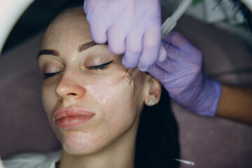 Fototapeta na wymiar Woman Getting Vacuum Cleaning Face Treatment At Beauty Clinic