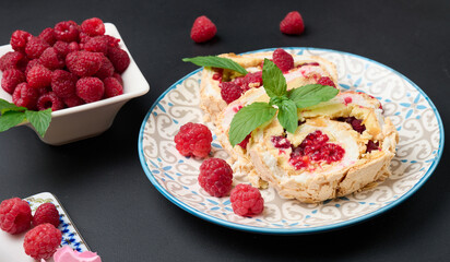 Baked meringue roll with cream and fresh red raspberry