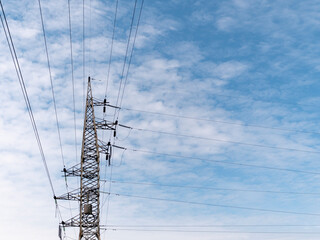 Concrete electric pole with wires against the sky