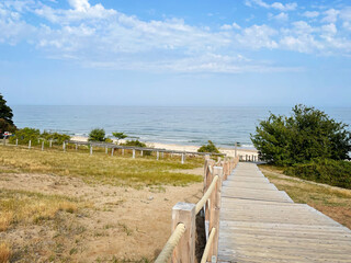 Empty footpath to the beautiful beach on a summer day. Scenic coastal landscape with the ocean in the background. Photo taken at Stenshuvud national park in Skåne, Sweden.