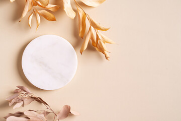 Dry natural grass, leaves and flowers with white marble podium beauty and fashion concept mock up
