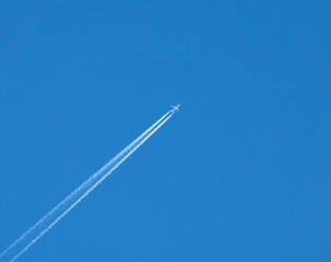 Airplane flies against a background of blue sky