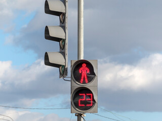 Traffic light for pedestrians with a prohibitory red color and a figure of a standing person