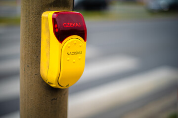 The button for pedestrians to cross the street at traffic light in Slubice, Poland. It says...