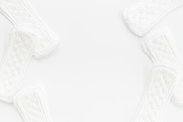 Female hygiene concept. White panty liners pattern, top view