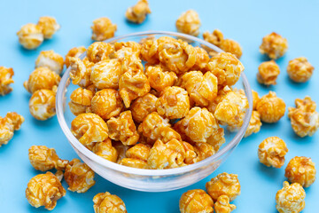 Honey caramel popcorn on blue background.