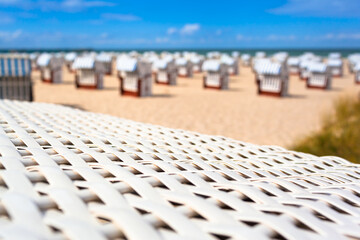 Holiday Relaxation Place at Coast / Detail braided white roof beach chair on foreground and defocused background of many more at summer beach - 526867671
