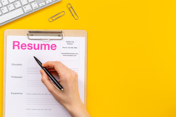 Hands with resume application form on office table. Find new job concept