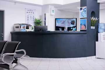 Facility registration counter in waiting area lobby, computer to make checkup appointments with healthcare report papers. Empty hospital reception desk with medical forms and insurance support.