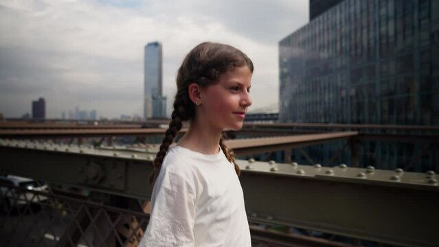 Young Teenage Girl Walking Over Brooklyn Bridge. Popular Tourist Destination