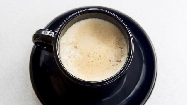 Cinemagraph of black cup with coffee
