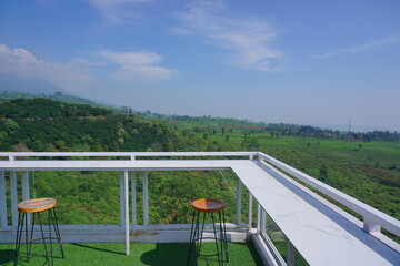 Table and chairs in the cafe with nature background. Natural cafe in the tea gardens. 