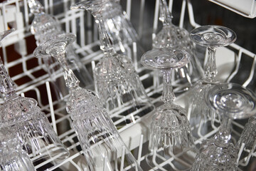 Close-up of some wine and champagne glasses in the tray of a dishwasher