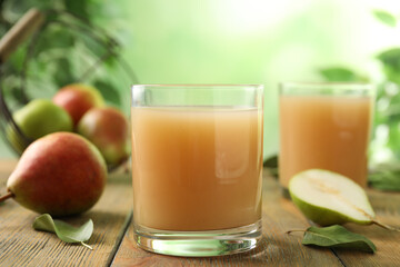 Fototapeta premium Fresh pear juice in glass on wooden table, closeup