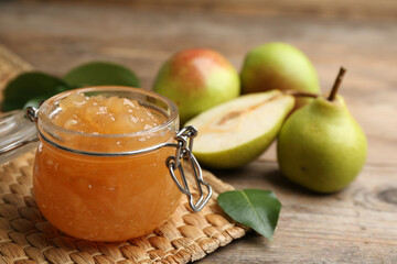 Delicious pear jam on wooden table ,closeup. Space for text