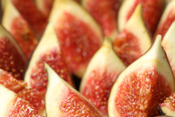 Slices of tasty fresh figs as background, closeup
