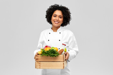 cooking, culinary and people concept - happy smiling female chef holding food in wooden box over...