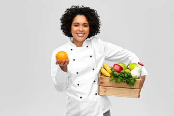 cooking, culinary and people concept - happy smiling female chef holding food in wooden box and...