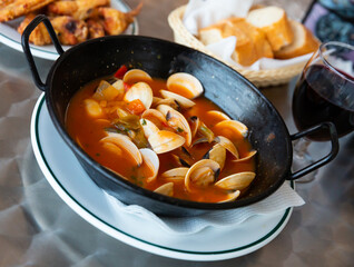 Delicious Spanish Tapas Almejas a la marinera - shellfish broth with vegetables
