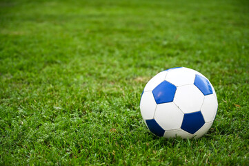 Ball for football on green grass on the stadium. Playing football match. Classic soccer ball. 