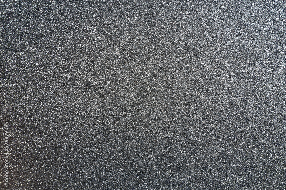 Poster black or dark gray background with shine. texture of rough paper or cardboard. defocused bokeh spark