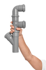Male plumber holding pipe fitting on white background, closeup