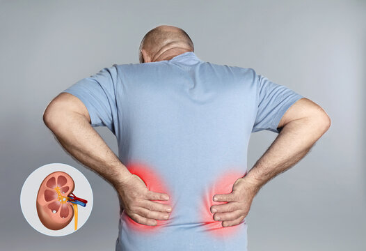 Senior man suffering from pain because of kidney stones disease on grey background