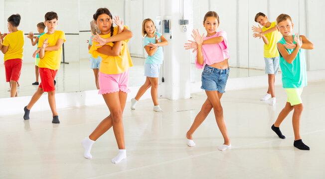 Portrait of group of boys and girls having dancing class in dance studio