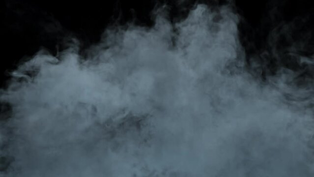 This stock motion graphics video shows slowly rising smoke or fog on transparent alpha channel background.