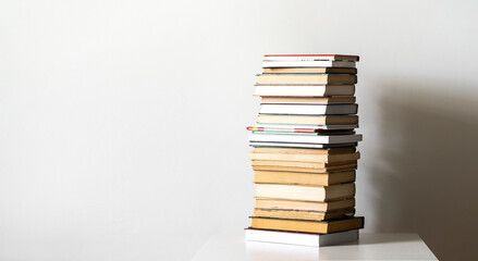 a stack of books on the shelf, concept of homework and studying