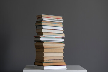 a stack of books on the shelf, concept of homework and studying