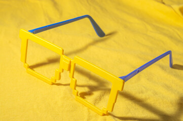 Glasses with Brazil colors, yellow and blue green, world cup concept with yellow background