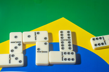 Domino game on top of a yellow and blue green flag,Brazilian colors,copy space