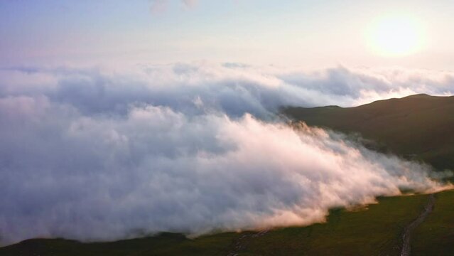 Sunset In Foggy Mountains, Dense Clouds Creeping Over Slanted Plateau, Aerial Shot From Drone